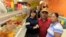 FILE - Diana Resendiz, from left, Alberto Resendiz and Maribel Resendiz pose for a photo at their business Mr. Tutis Fruties in Florida City, Florida, June 27, 2017. 
