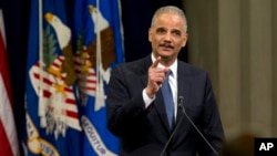 Attorney General Eric Holder speaks at a farewell gathering at the Justice Department in Washington, April 24, 2015. Holder was bidding farewell to the Justice Department after six years as the nation's top law enforcement official.