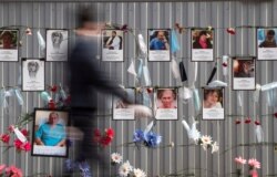 Medical face masks and portraits of St.Petersburg's medical workers who died from coronavirus infection during their work, hang at a makeshift memorial in front of the local health department in St.Petersburg, Russia, May 14, 2020.