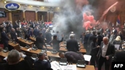 This image taken from video released by the National Assembly of Serbia in Belgrade on March 4, 2025, shows opposition lawmakers lighting flares and discharging suspected tear gas during a session of parliament in support of ongoing corruption protests.