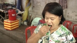 Ni Ni Wah puts a betel quid in her mouth. She dismisses the risks of cancer saying “mouth cancer happens to people who keep betel quids in their mouth all night while they sleep.” (Dave Grunebaum/VOA)