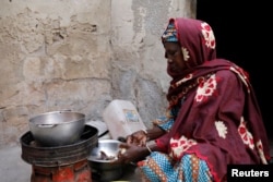 Astou Mandiang cooks the meal for her family, for the breaking of the Muslim fast during the holy month of Ramadan at her home in Dakar