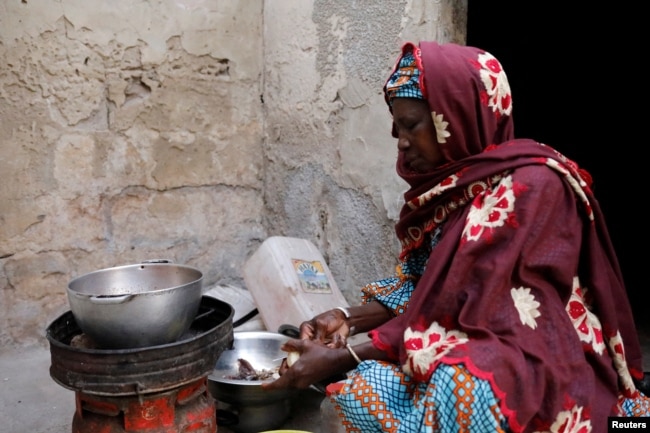 Astou Mandiang cooks the meal for her family, for the breaking of the Muslim fast during the holy month of Ramadan at her home in Dakar