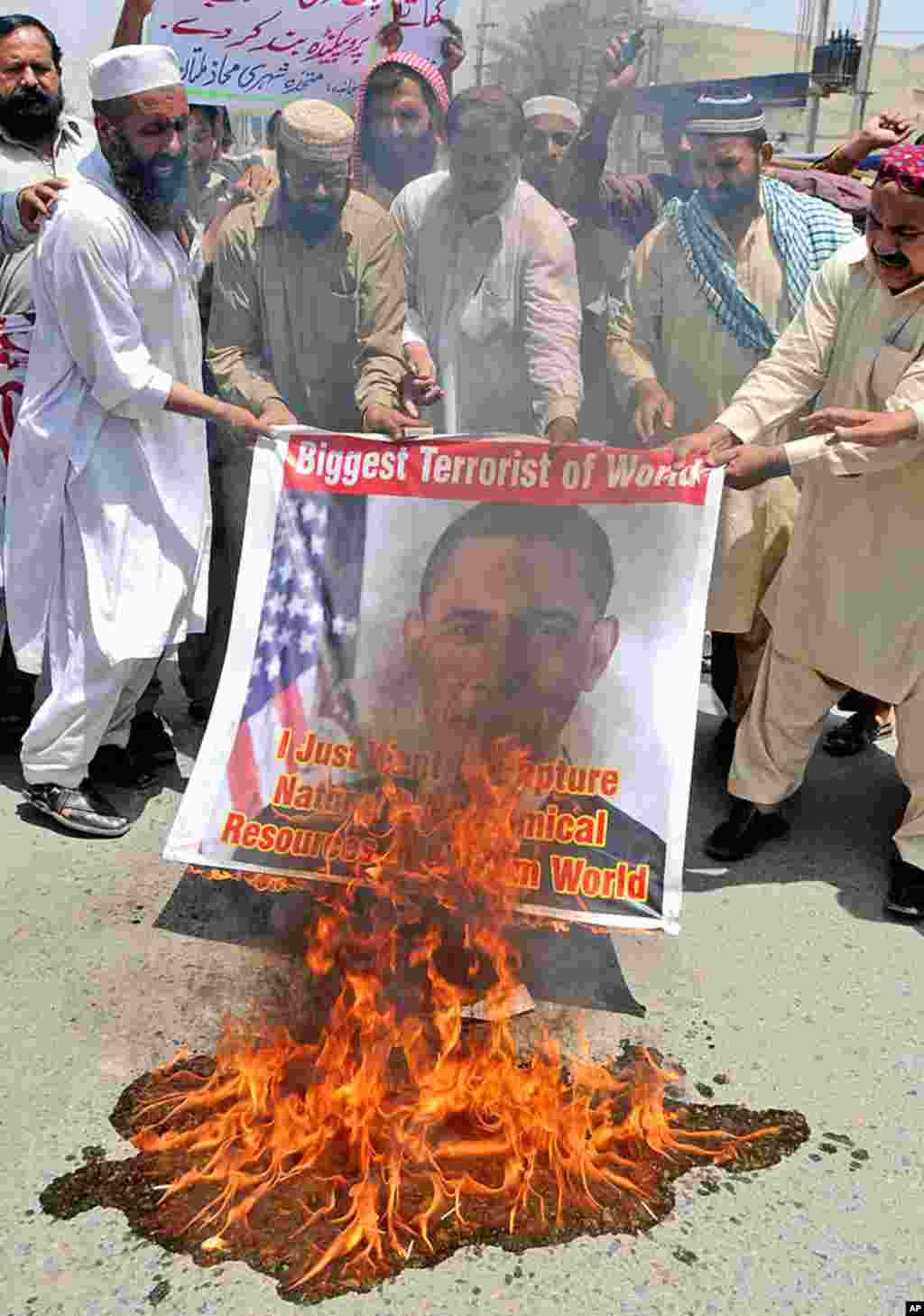 Activists from Muthahida Shehri Mahaz burn a banner depicting U.S. President Barack Obama during a rally to condemn the killing of al-Qaida leader Osama bin Laden, in Multan, Pakistan, May 8, 2011.&nbsp;