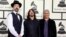 FILE - Nirvana and Foo Fighters musicians (L-R) Krist Novoselic, Dave Grohl and Pat Smear arrive at the 56th annual Grammy Awards in Los Angeles, Jan. 26, 2014.