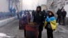 Supporters of former Georgian President Mikheil Saakashvili warm themselves at a fire as they gathered in a narrow street outside the police station where he was taken in Kyiv, Ukraine, Dec. 9, 2017. 