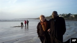 Franco-Togolese dual national politician Kofi Yamgnane walks with his wife Anne-Marie on the beach of Saint-Nic, western France, on 14 Nov 2009