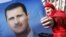 A pro-Syrian regime protester holds a portrait of Syrian President Bashar Assad during a demonstration to show support for their president, in Damascus, Syria. (File)