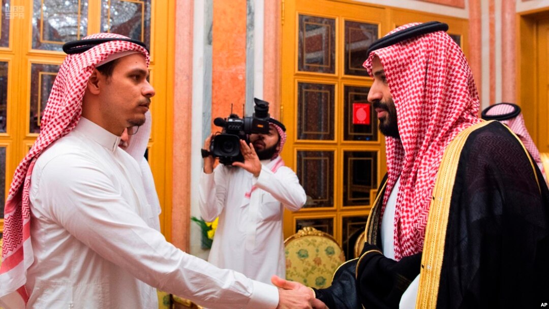 FILE - Photo released by Saudi Press Agency, SPA, shows Saudi Crown Prince Mohammed bin Salman (R) shaking the hand of Salah Khashoggi, son of Jamal Khashoggi, in Riyadh, Saudi Arabia, Oct. 23, 2018.