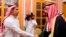 FILE - Photo released by Saudi Press Agency, SPA, shows Saudi Crown Prince Mohammed bin Salman (R) shaking the hand of Salah Khashoggi, son of Jamal Khashoggi, in Riyadh, Saudi Arabia, Oct. 23, 2018.