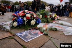 Floral tributes to Samuel Paty are seen at the Place de la Republique, in Lille, France, Oct. 18, 2020.