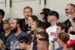 Britain's Prince Harry, top left, and Meghan, Duchess of Sussex, watch during the first inning of a baseball game between the Boston Red Sox and the New York Yankees, June 29, 2019, in London. (AP)