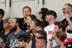 Britain's Prince Harry, top left, and Meghan, Duchess of Sussex, watch during the first inning of a baseball game between the Boston Red Sox and the New York Yankees, June 29, 2019, in London. (AP)