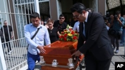 Relative and friends of slain journalist Mauricio Solis carry his coffin during his wake in Uruapan, Mexico, Oct. 30, 2024.