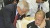 Philippines' President Benigno Aquino III, right, talks with his Foreign Minister Albert del Rosario, left, during the retreat meeting at the 20th ASEAN Summit at the Peace Palace in Phnom Penh Cambodia, April 4, 2012.