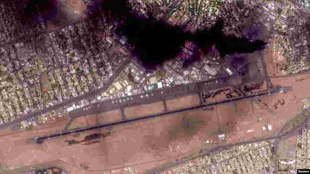 Satellite image shows smoke and an overview of Khartoum International Airport in Khartoum, Sudan. (Reuters)