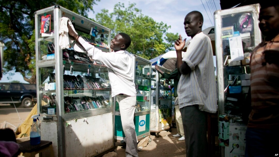 FILE - A mobile phone vendor from Cameroon prepares for a day of business in Juba, southern Sudan.