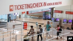 Passengers approach gate security for flights out of Love Field in Dallas, Texas, June 24, 2020.