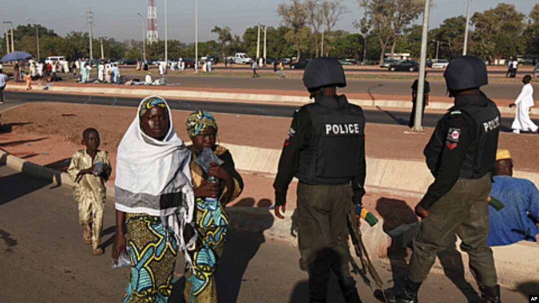 Nigerian police patrol as people attend prayers marking the muslim festival of Eid al-Adha in the capital Abuja, November 6, 2011.