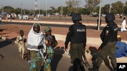 Nigerian police patrol as people attend prayers marking the muslim festival of Eid al-Adha in the capital Abuja, November 6, 2011.