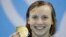 United States' Katie Ledecky shows off her gold medal after setting a new world record in the women's 400-meter freestyle final during the swimming competitions at the 2016 Summer Olympics, Aug. 8, 2016, in Rio de Janeiro, Brazil. 