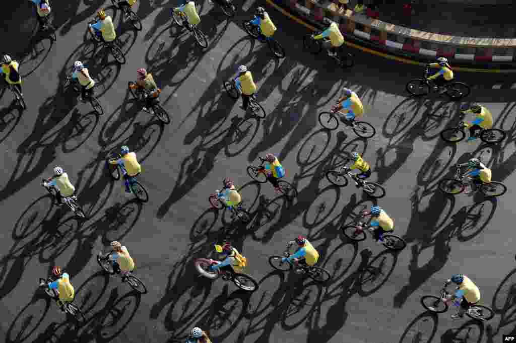 People ride bicycles during a mass cycle event to honor King Bhumibol Adulyadej in Narathiwat, southern Thailand. Crown prince Maha Vajiralongkorn led the symbolic &#39;Bike for Dad&#39; event in Bangkok as people rode bicycles nationwide to celebrate the king&#39;s 88th birthday.