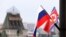 FILE - Flags of Russia and North Korea are seen in front of the central railway station in Vladivostok, Russia, April 24, 2019. 