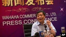 FILE - In this July 17, 2013 photo, Zong Qinghou, chairman of food and beverage giant Wahaha Group, smokes as he speaks to the journalists during a news conference in Beijing, China. 