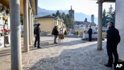 A moment of a funeral service without relatives in the cemetery of Zogno, near Bergamo, Northern Italy, Saturday, March 21, 2020. Italy’s tally of coronavirus cases and deaths keeps rising, with new day-to-day highs: 793 dead and 6,557 new cases…