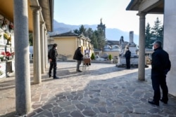 A moment of a funeral service without relatives in the cemetery of Zogno, near Bergamo, Northern Italy, March 21, 2020.