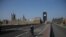 FILE - A cyclist crosses a near-empty Westminster Bridge with the Houses of Parliament in the background, amid the coronavirus outbreak, in central London, Britain, April 9, 2020.