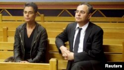 FILE - Jacob "Kobi" Alexander sits with his wife, Hanna, as he awaits the start of his extradition hearing in Windhoek, Namibia, Sept. 17, 2008.