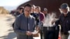 FILE - A man from China gets a bowl of oatmeal as he waits to apply for asylum after crossing the border with Mexico, Oct. 24, 2023, near Jacumba, California. U.S. authorities are stepping up efforts to return undocumented Chinese nationals to their homeland.