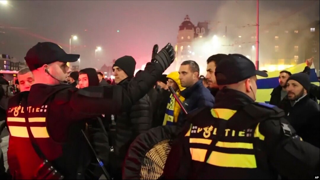In this image taken from video, police escort Maccabi Tel Aviv supporters to the metro station leading them to the Ajax stadium, after pro-Palestinian supporters marched near the stadium, in Amsterdam, the Netherlands, Nov. 7, 2024.