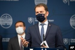 Prime Minister Igor Matovic, front, announces the resignation of Health Minister Marek Krajci, left, in Bratislava, March 11, 2021.