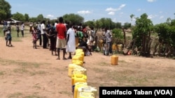 South Sudanese wait to fill a long line of jerry cans at a borehole in the Ocea sector of Rhino refugee resettlement camp in Uganda. 