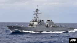 This US Navy photo obtained Oct. 23, 2018 shows the Arleigh Burke-class guided-missile destroyer USS Curtis Wilbur as it participates in a close quarters maneuvering exercise on Feb. 28, 2018 in the Philippine Sea. 