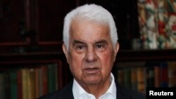 FILE - Turkish Cypriot leader Dervis Eroglu attends a photo call during a meeting with the leaders of the Greek and Turkish Cyprus communities at the Greentree estate in Manhasset, New York.