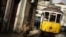A woman walks near a tram at the Alfama neighborhood in Lisbon, Portugal, January 22, 2013. 
