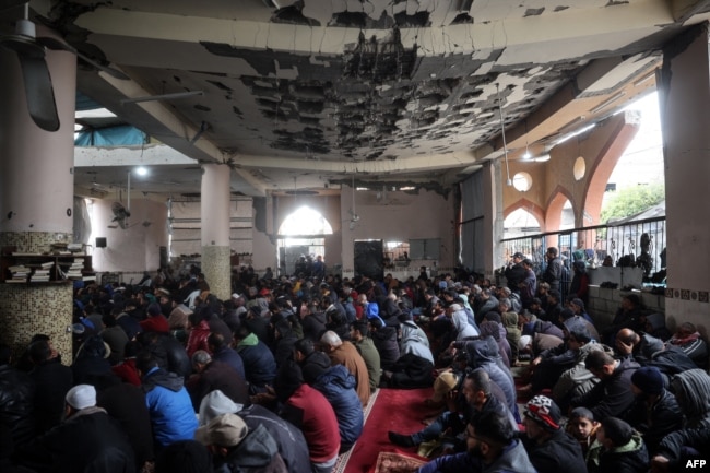 Palestinians gather inside a war-damaged mosque to perform the Friday noon prayer during the Muslim holy fasting month of Ramadan, in the Nuseirat refugee camp in the central Gaza Strip on March 7, 2025.