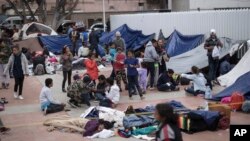 Migrants wait for access to request asylum in the US, at the El Chaparral port of Entry in Tijuana, Mexico, April 30, 2018. 