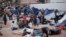 Migrants wait for access to request asylum in the US, at the El Chaparral port of Entry in Tijuana, Mexico, April 30, 2018. 