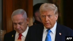 TOPSHOT - US President Donald Trump and Israel's Prime Minister Benjamin Netanyahu arrive to hold a press conference in the East Room of the White House in Washington, DC, on February 4, 2025.