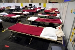 Cots are shown in a dormitory at an emergency shelter for migrant children July 2, 2021, in Pomona, Calif.