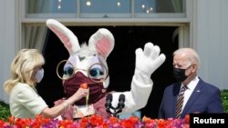 U.S. President Joe Biden,&nbsp;first lady Jill Biden and a person wearing an Easter Bunny costume are see on the Blue Room Balcony of the White House in Washington.