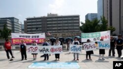 Protesters stand with banners to oppose planned joint military exercises between South Korea and the United States near the U.S. embassy in Seoul, South Korea, Monday, Aug. 5, 2019. The both countries are preparing to hold their annual joint…