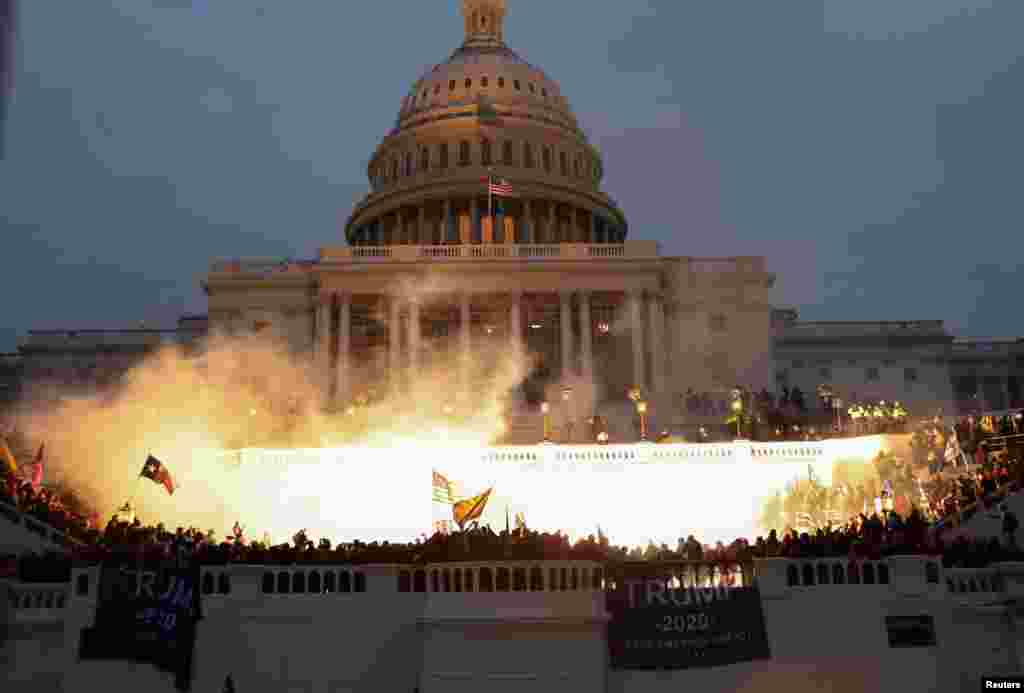 An explosion caused by a police munition is seen while supporters of U.S. President Donald Trump gather in front of the U.S. Capitol Building in Washington, Jan. 6, 2021. 