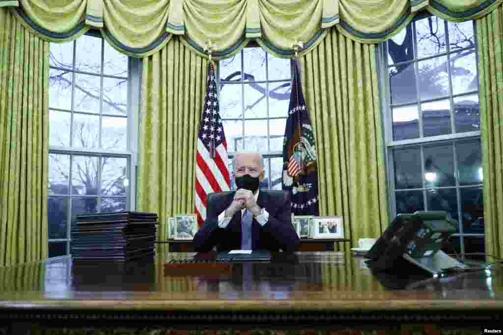 U.S. President Joe Biden signs executive orders in the Oval Office