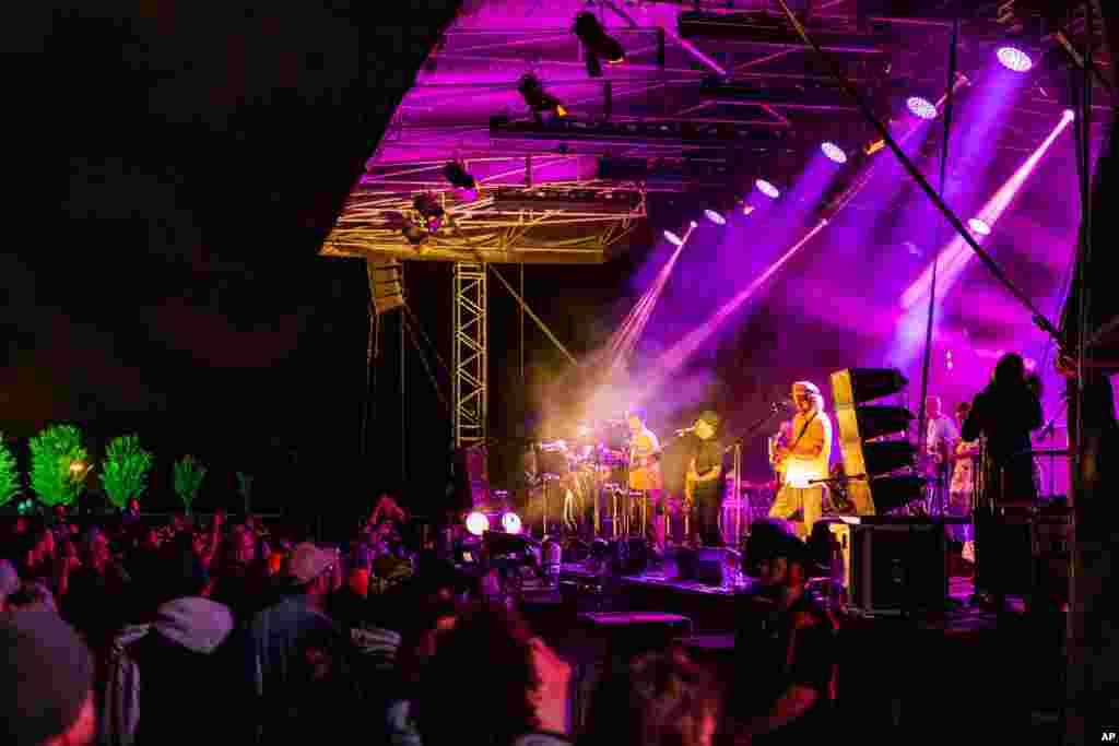 People watch New Zealand band The Black Seeds perform during New Year's Eve celebrations at Hagley Park in Christchurch, Jan. 1, 2021.
