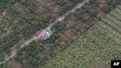 FILE - In this photo released by the Malacanang Photo Bureau shows damage on crops after flash floods caused by a powerful typhoon hit Compostela Valley, southern Philippines.